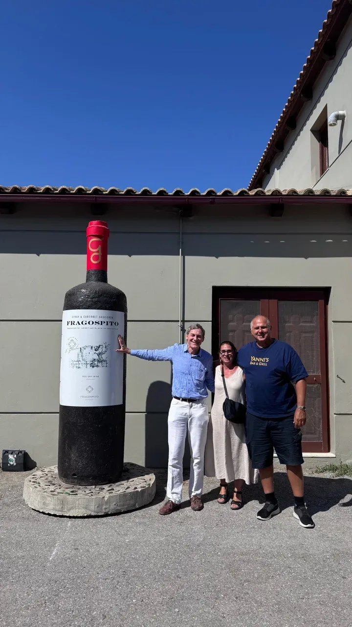 Yanni, Denise and cousin George (Giorgos) beside the giant Fragospito bottle outside the winery