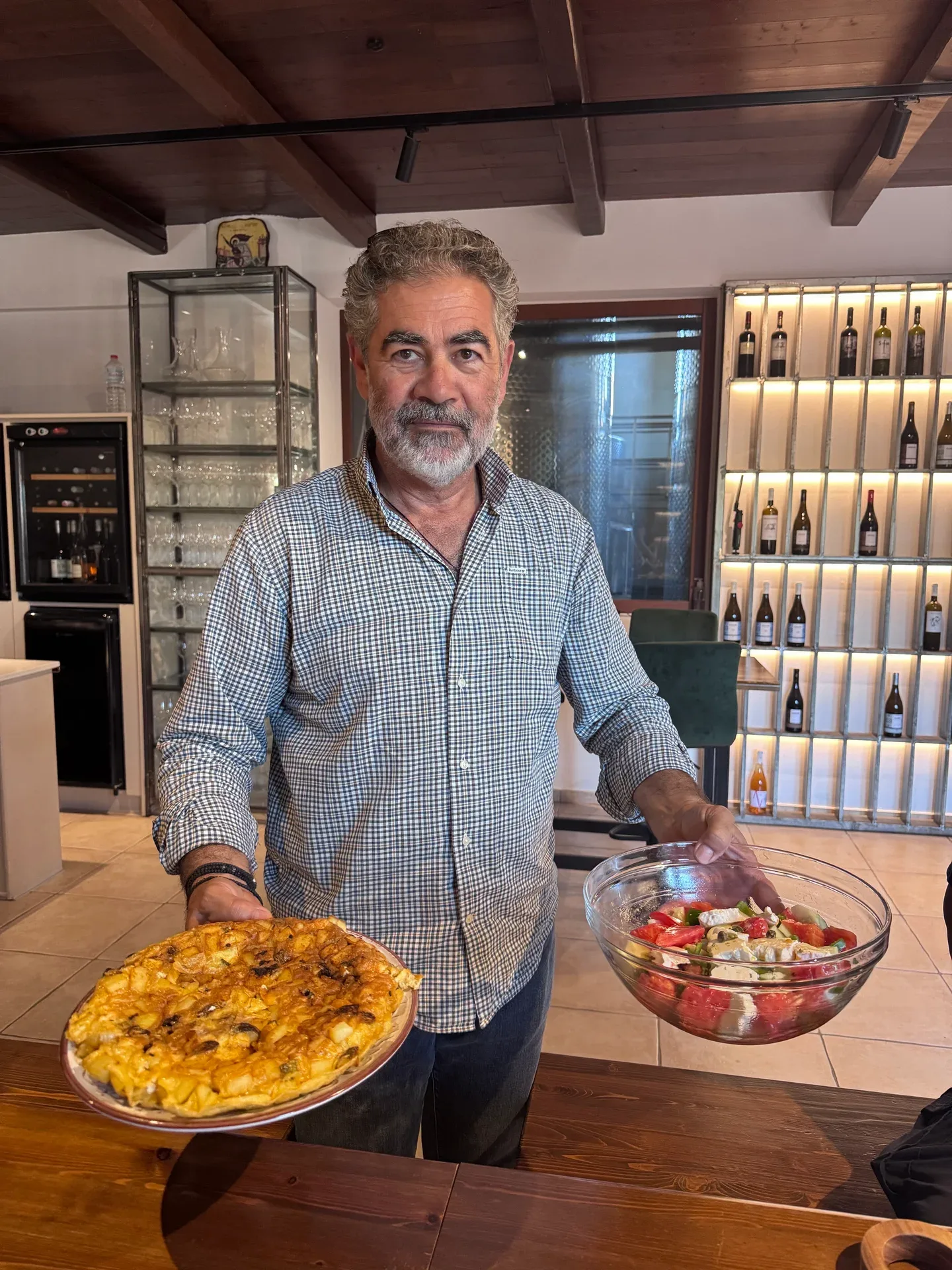Our host carrying a homemade omelette and a bowl of garden salad to the table