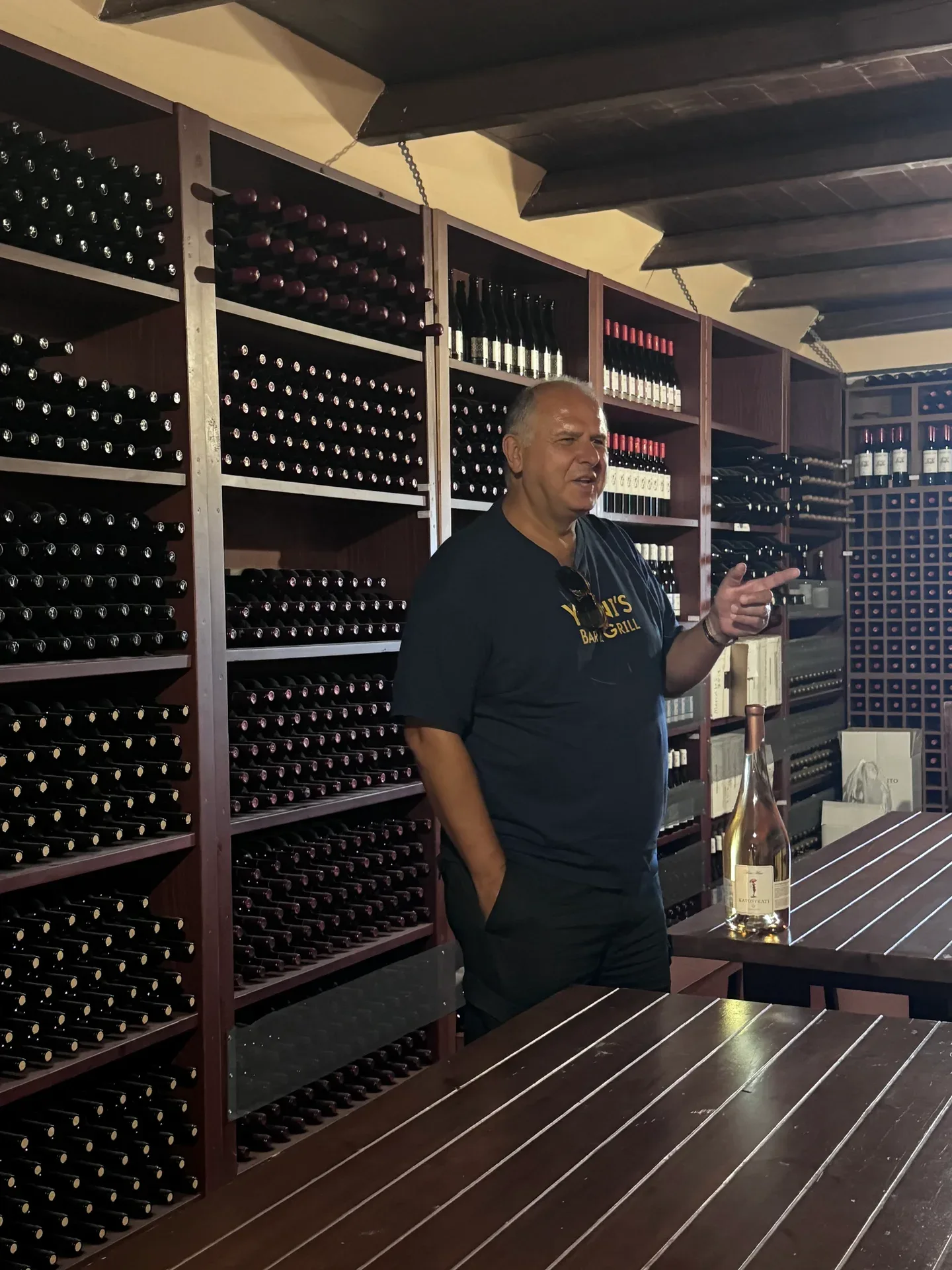 Yanni talking among shelves of wine in the cellar