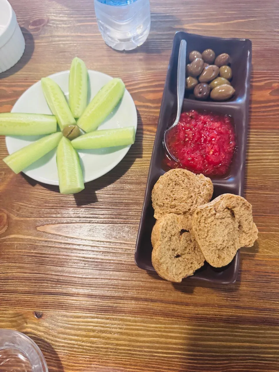Cucumbers, olives, grated tomato and rusks arranged on the tasting table