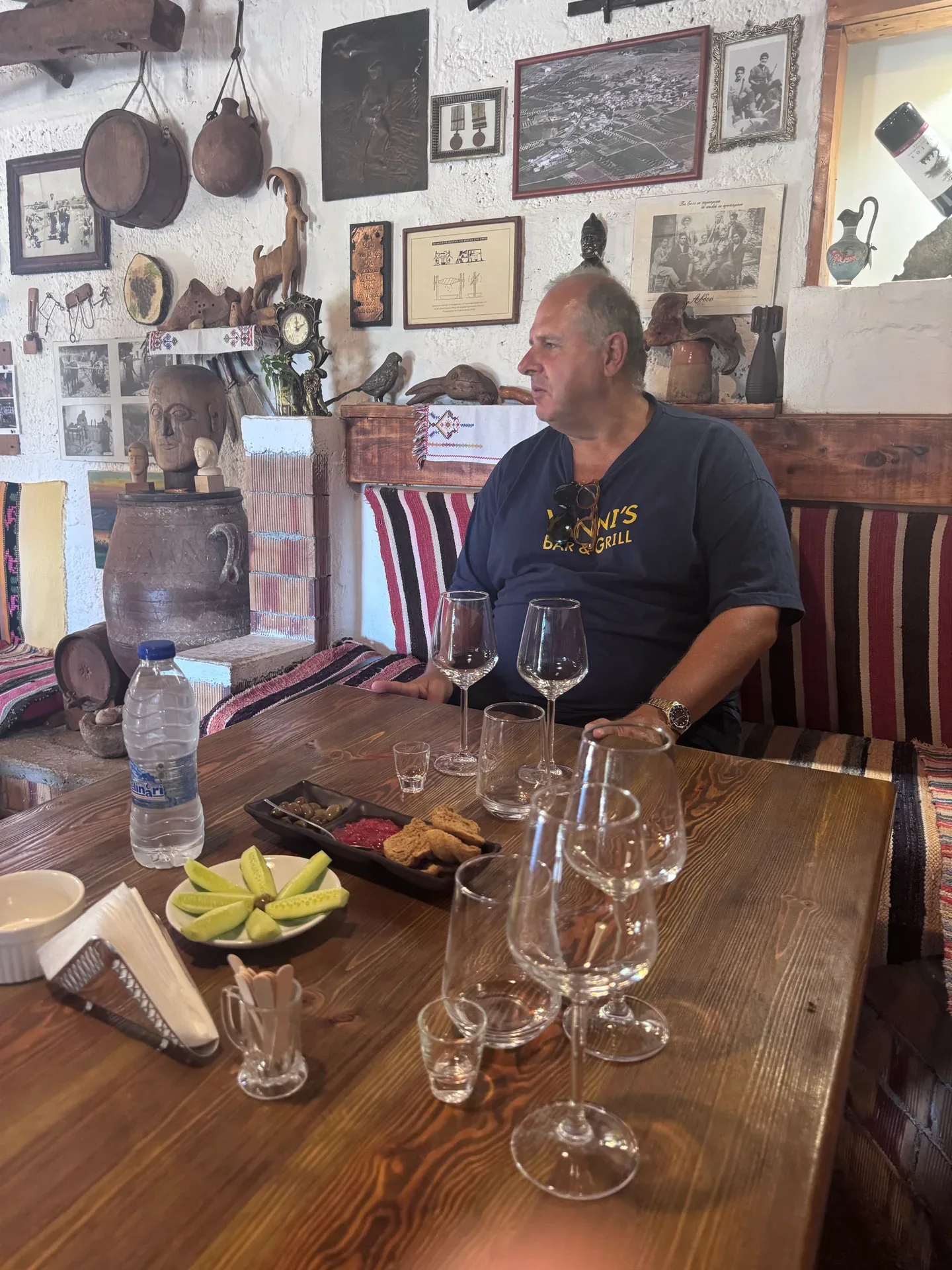 Yanni seated in the Karapidakis tasting room with wine glasses