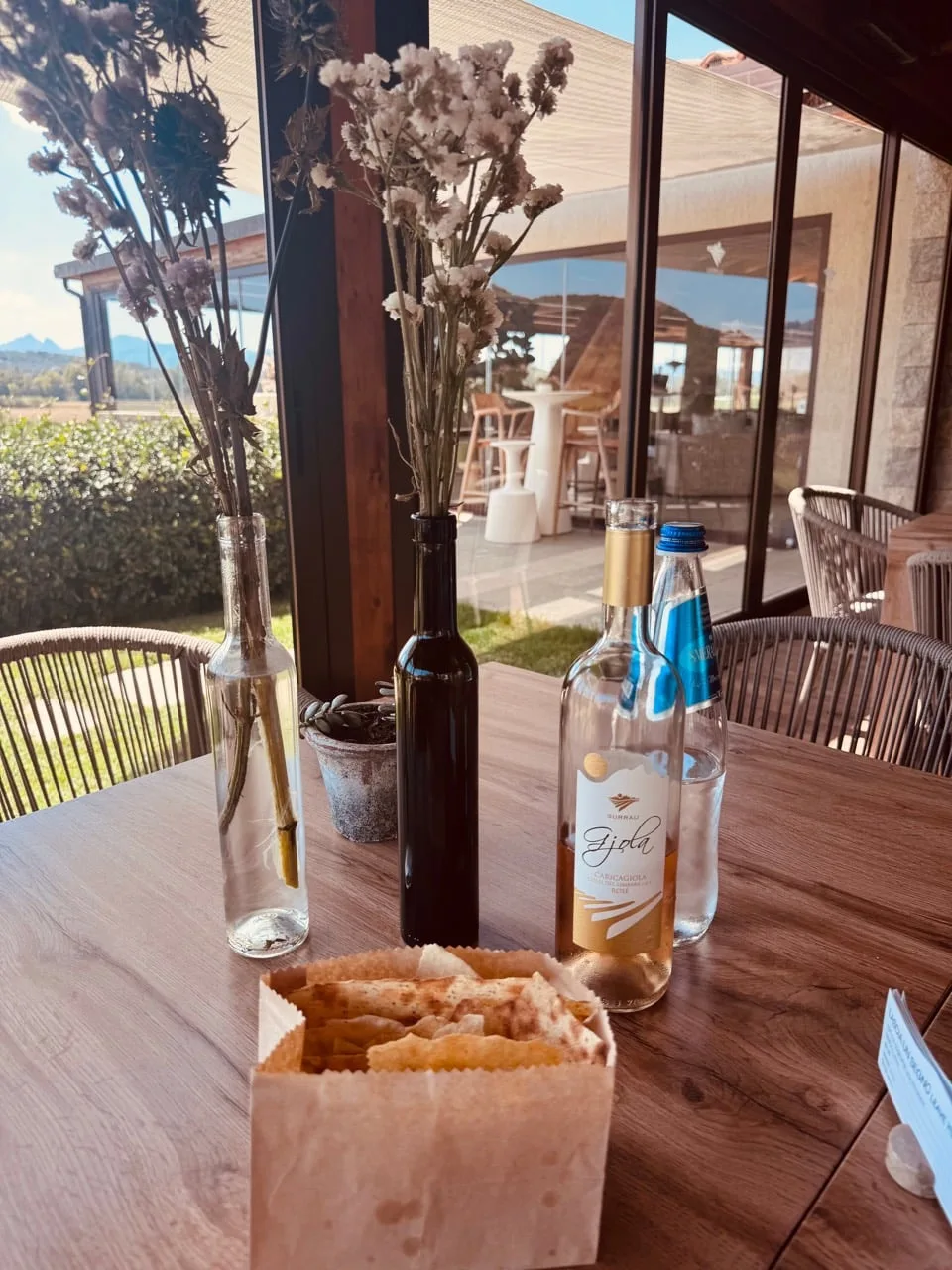Surrau rosato, water and crisp bread on the lunch table