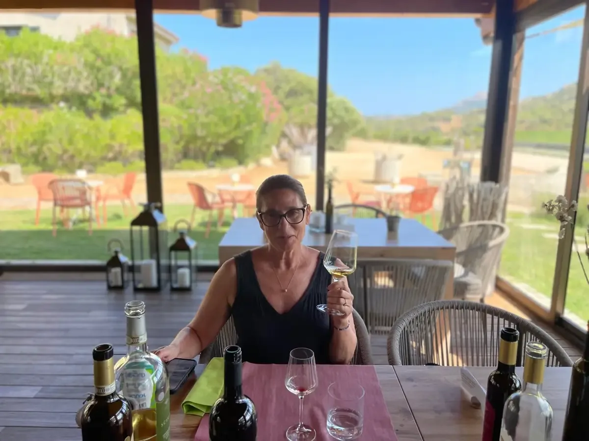 Denise tasting wine at the Surrau lunch table
